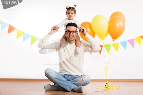 Image of father and daughter with birthday party balloons