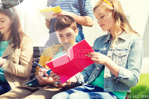 Image of group of students with notebooks at school yard