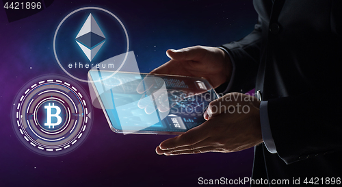 Image of businessman with tablet pc and cryptocurrency