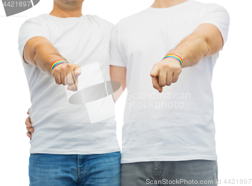 Image of couple with gay pride rainbow wristbands