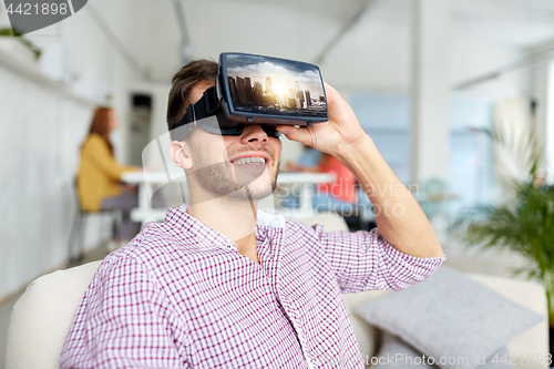 Image of happy man with virtual reality headset at office