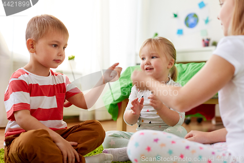 Image of kids playing rock-paper-scissors game at home