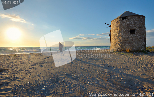 Image of Young girl on the sunset beach