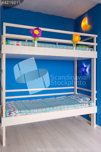 Image of Children\'s bunk wooden bed in the interior of the room