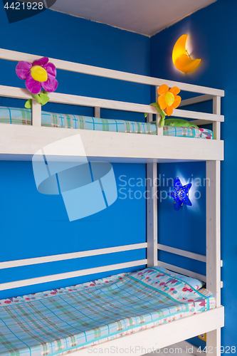 Image of Fragment of a children\'s bunk wooden bed in the interior of the room