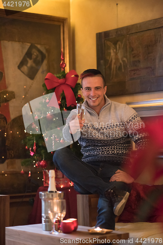 Image of Happy young man with a glass of champagne