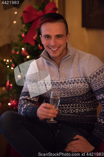 Image of Happy young man with a glass of champagne