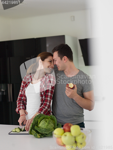 Image of Young handsome couple in the kitchen
