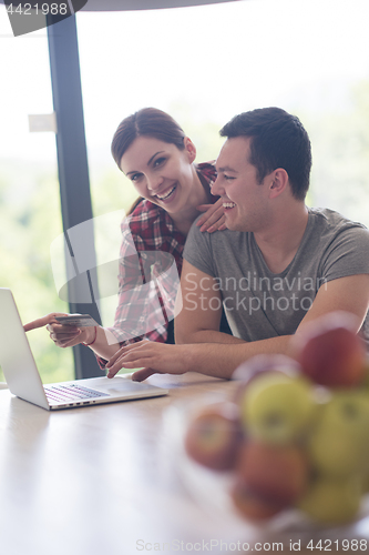 Image of happy young couple buying online