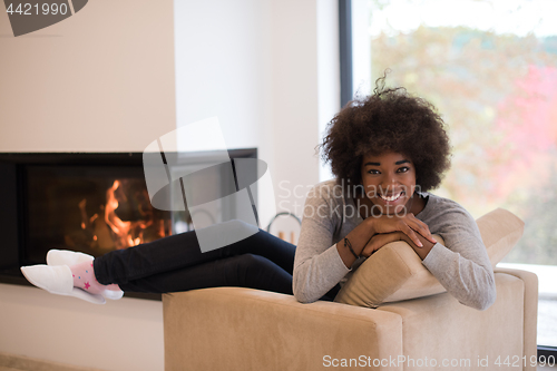 Image of black woman in front of fireplace