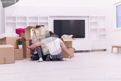 Image of young couple moving  in new house