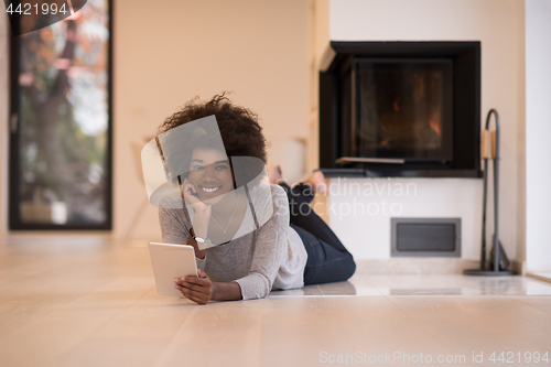 Image of black women using tablet computer on the floor