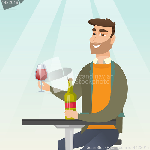 Image of Man drinking wine in the restaurant.