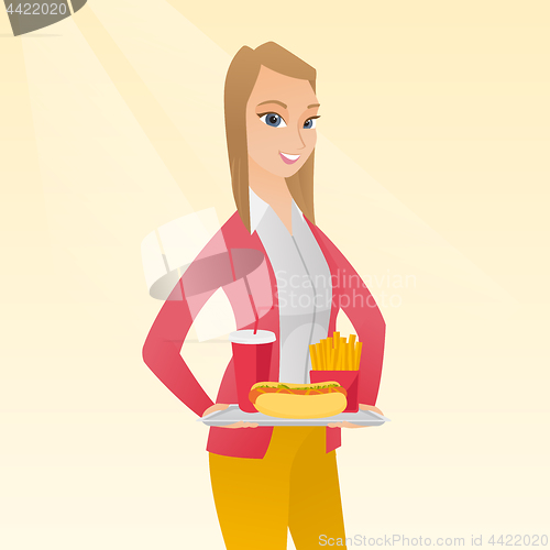 Image of Woman holding tray full of fast food.