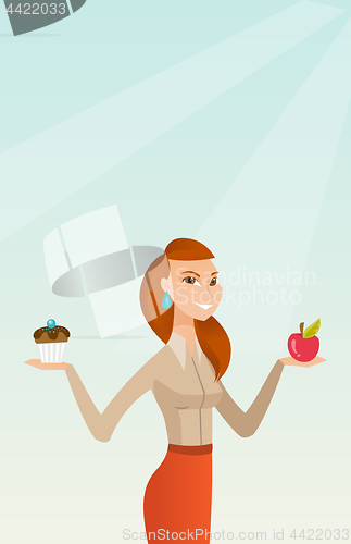 Image of Woman choosing between apple and cupcake.