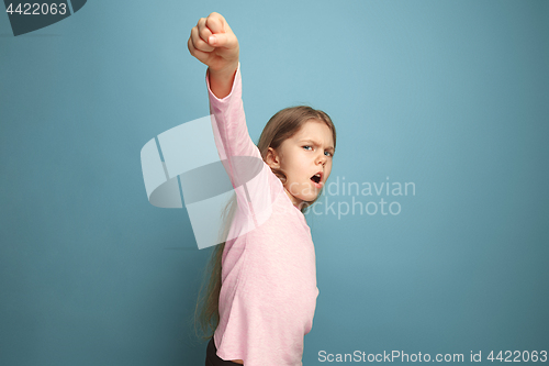 Image of The call for struggle. Teen girl on a blue background. Facial expressions and people emotions concept