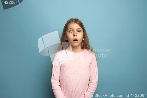 Image of The surprise. Teen girl on a blue background. Facial expressions and people emotions concept