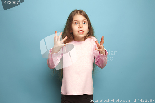 Image of The surprise, happiness, joy, victory, success and luck. Teen girl on a blue background. Facial expressions and people emotions concept