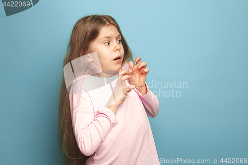 Image of The fear. Teen girl on a blue background. Facial expressions and people emotions concept