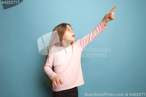 Image of The determination. Teen girl on a blue background. Facial expressions and people emotions concept