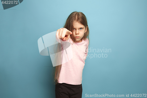 Image of The determination. Teen girl on a blue background. Facial expressions and people emotions concept