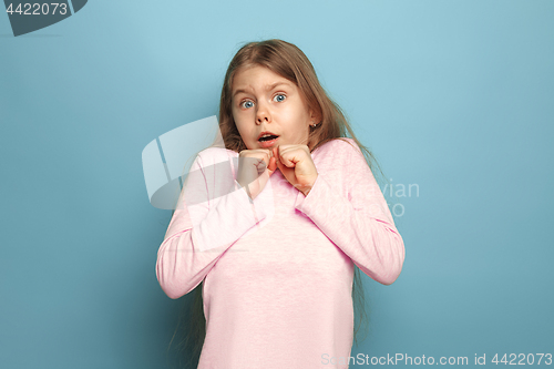 Image of The fear. Teen girl on a blue background. Facial expressions and people emotions concept