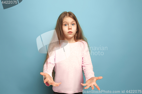 Image of The surprise. Teen girl on a blue background. Facial expressions and people emotions concept