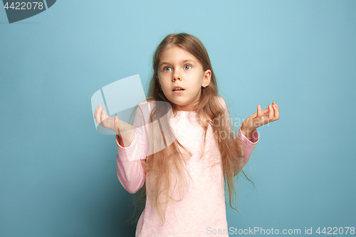 Image of The surprise. Teen girl on a blue background. Facial expressions and people emotions concept