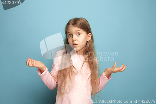 Image of The surprise. Teen girl on a blue background. Facial expressions and people emotions concept