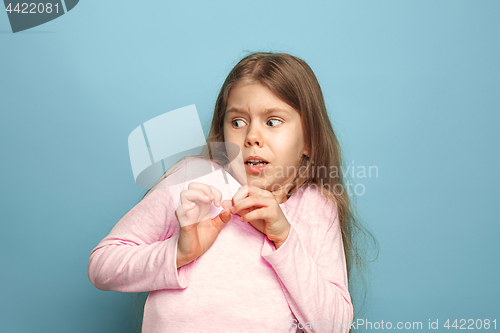 Image of The fear. Teen girl on a blue background. Facial expressions and people emotions concept