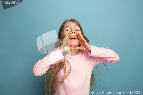 Image of The emotional blonde teen girl have a happiness look and screaming. Studio shot
