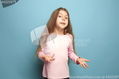 Image of The surprise. Teen girl on a blue background. Facial expressions and people emotions concept