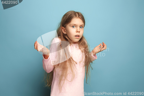 Image of The surprise. Teen girl on a blue background. Facial expressions and people emotions concept