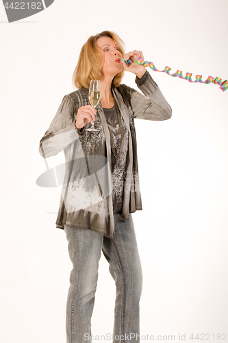 Image of elderly woman blows when celebrating a streamer from