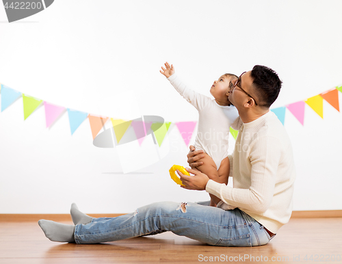 Image of happy father and little daughter at birthday party