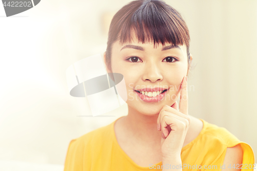 Image of happy asian young woman at home