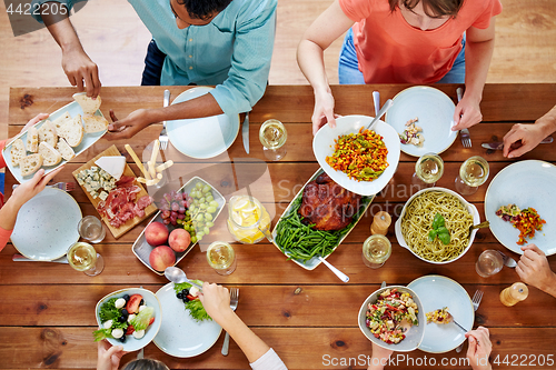 Image of group of people eating at table with food