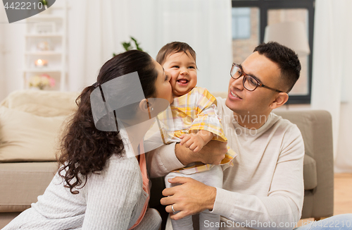 Image of happy family with baby daughter at home