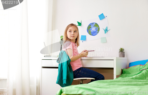 Image of little girl doing homework or drawing at home