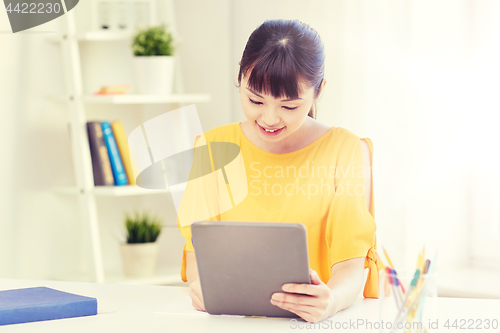 Image of asian woman student with tablet pc at home