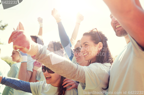 Image of group of volunteers celebrating success in park