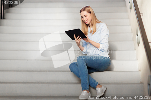 Image of woman or student with tablet pc sitting on stairs