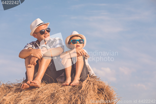 Image of Father and son playing in the park at the day time.