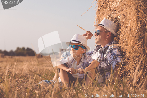 Image of Father and son playing in the park at the day time.