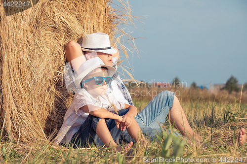 Image of Father and son playing in the park at the day time.