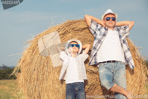 Image of Father and son playing in the park at the day time.