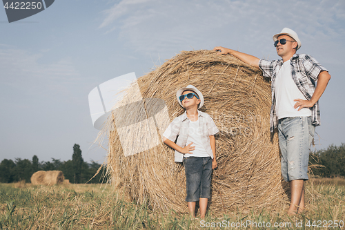 Image of Father and son playing in the park at the day time.