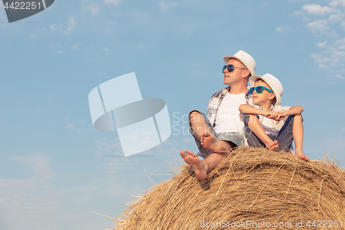 Image of Father and son playing in the park at the day time.