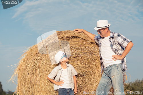 Image of Father and son playing in the park at the day time.