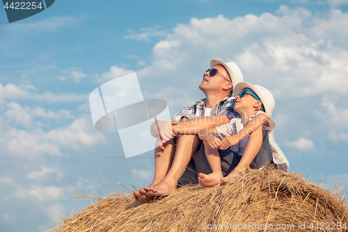 Image of Father and son playing in the park at the day time.